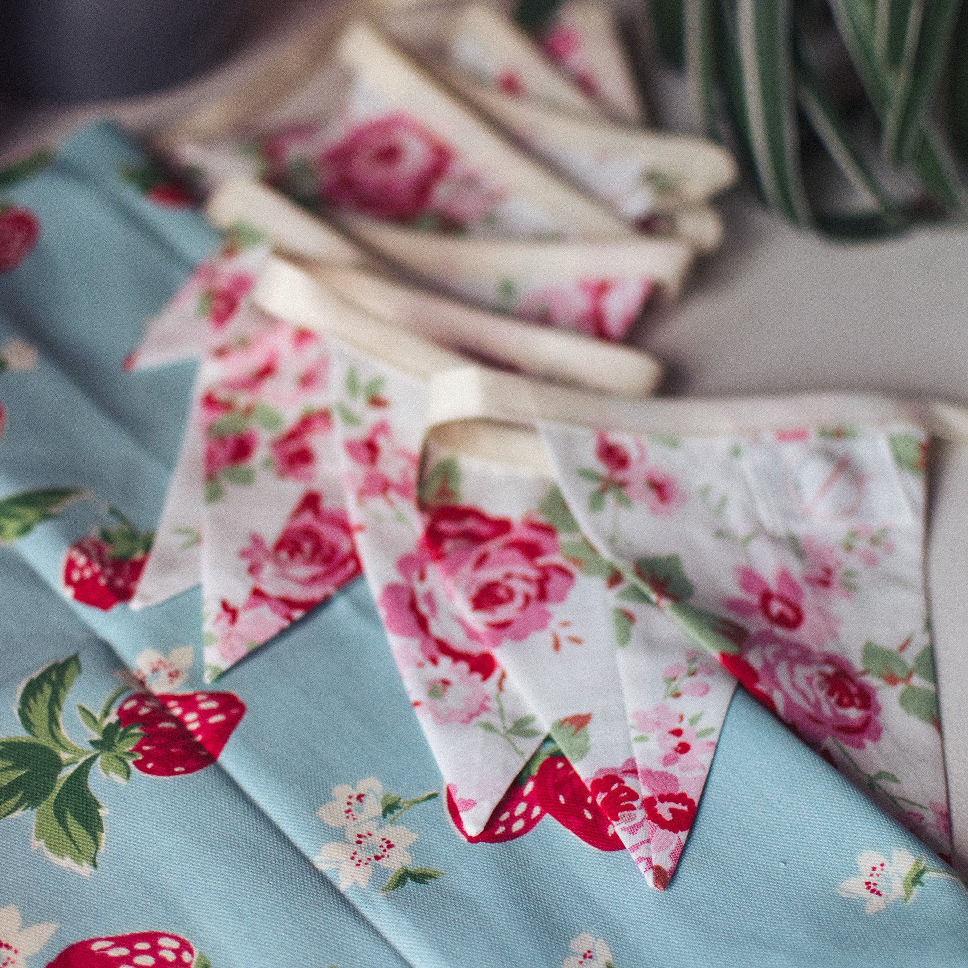 Rosali Vintage Style Cath Kidston Bunting - Against a vibrant strawberry print, showcasing its reversible design and elegance
