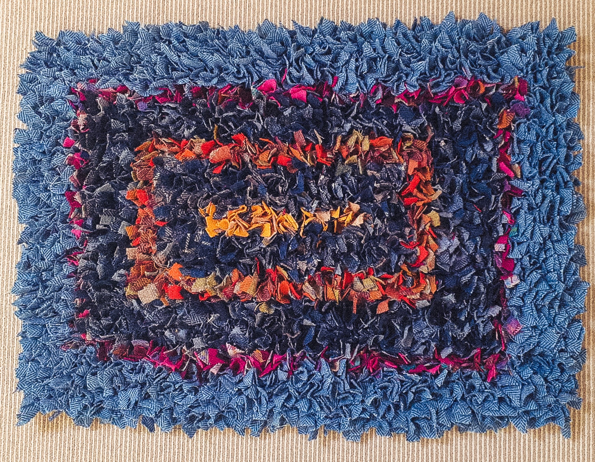 Handmade Concentric Rectangles Rag Rug - A 2ft x 3ft hessian and wool rug with predominantly blue rectangles, accented by contrasting red and orange rectangles