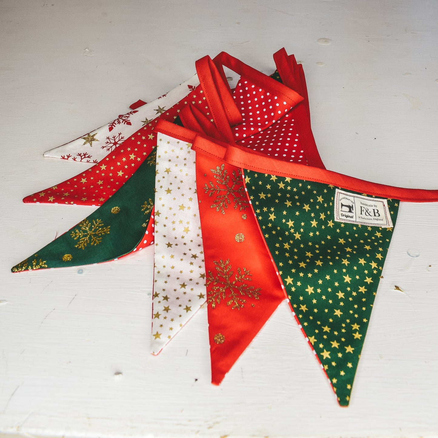 Red and Green Christmas Bunting Handmade by F&B featuring stars and snowflakes on christmas colours 3m in length